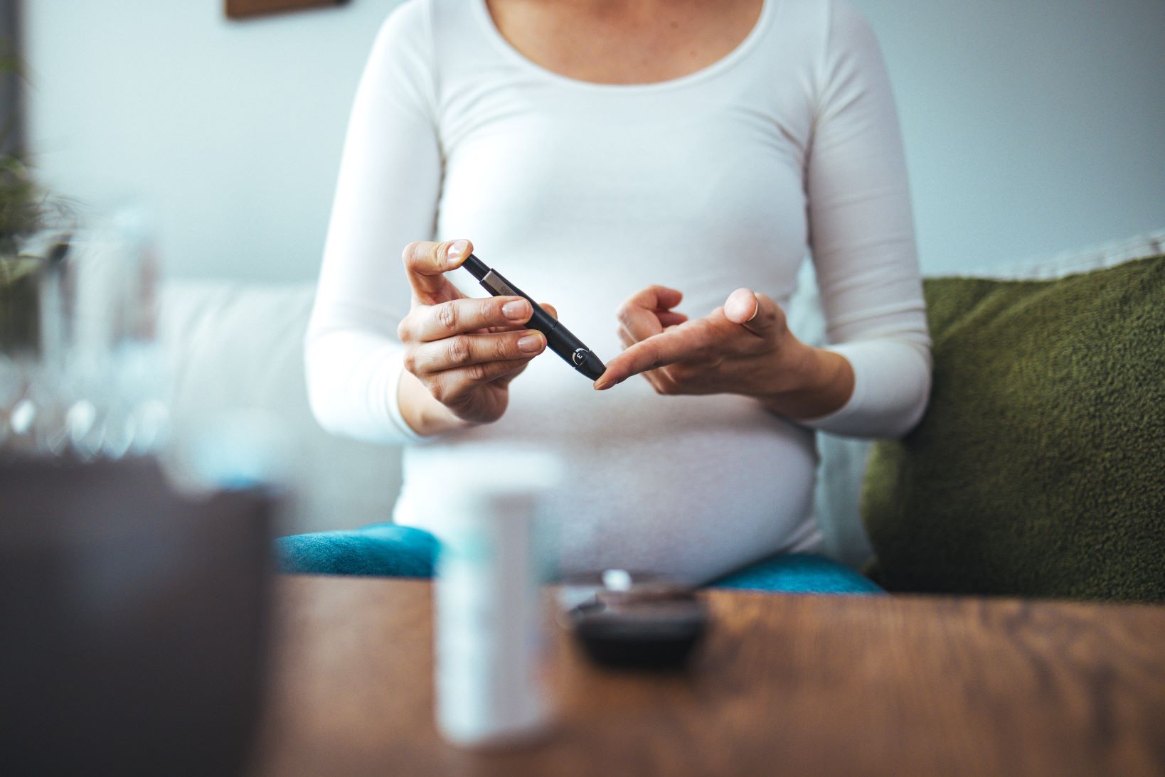 Pregnant woman checking blood glucose