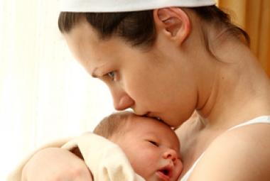 Woman kissing infant