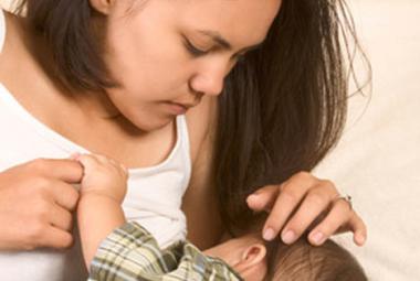 Breastfeeding mom looking at baby