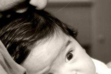 Mom kissing baby head