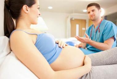Pregnant woman with doctor