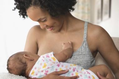Breastfeeding mom smiling at baby
