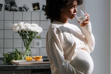 Pregnant woman holding drink