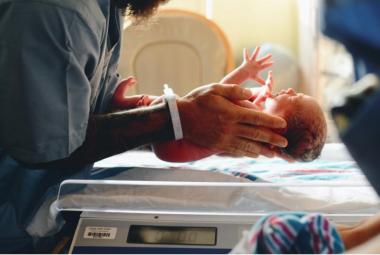 Nurse holding infant